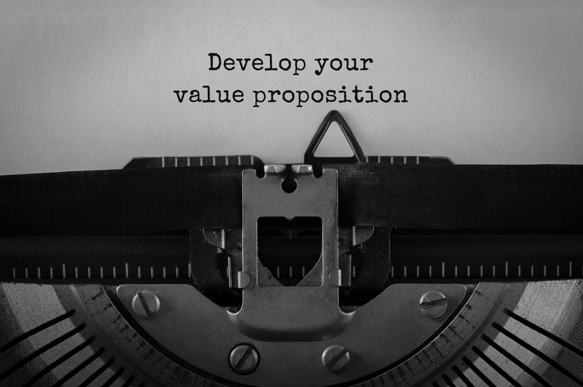 Text Develop your value proposition typed on retro typewriter